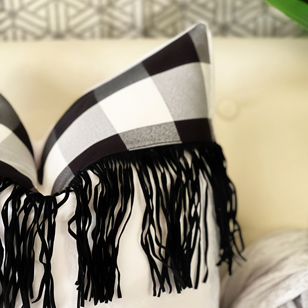 Plush white pillow with fringe
