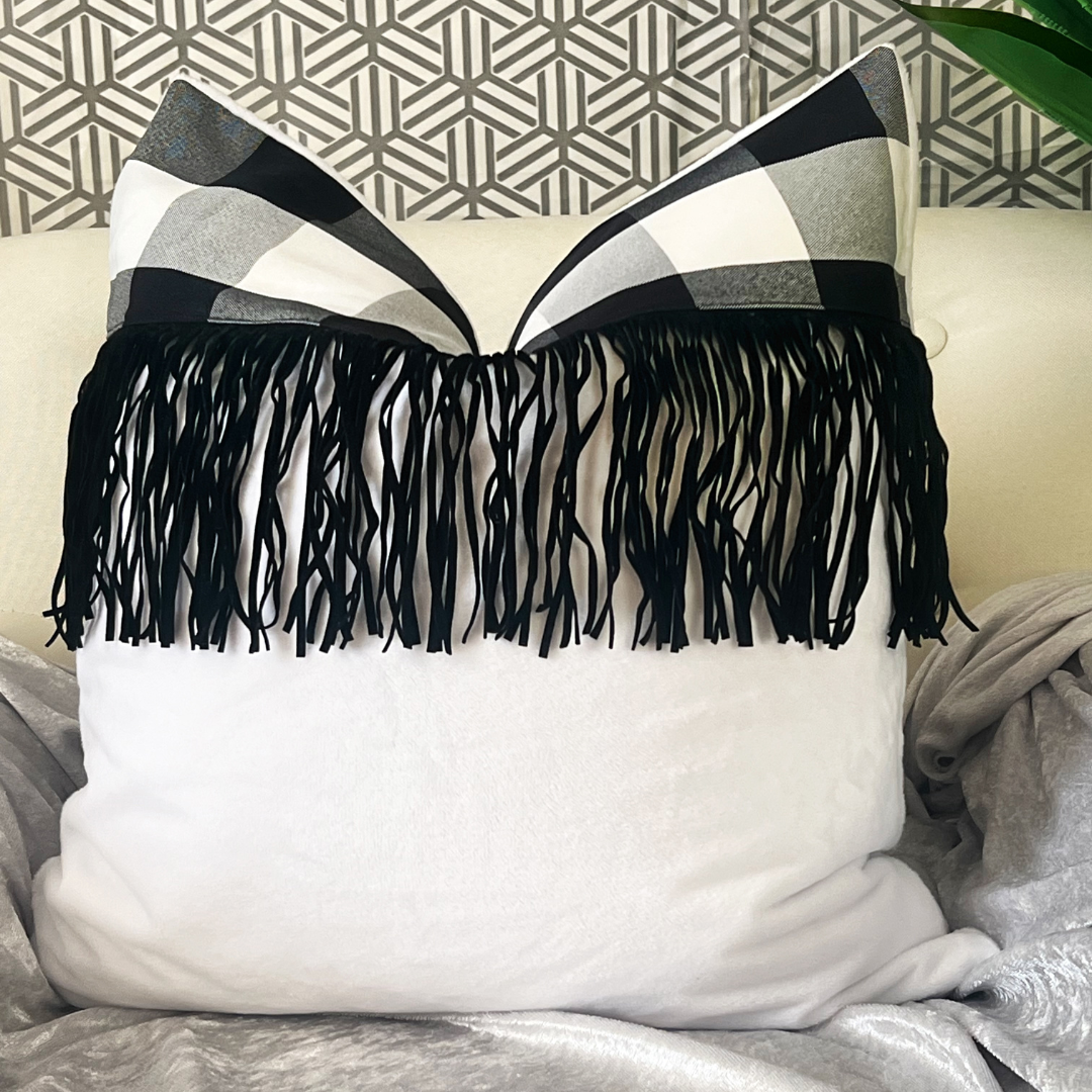 Plush white pillow with fringe