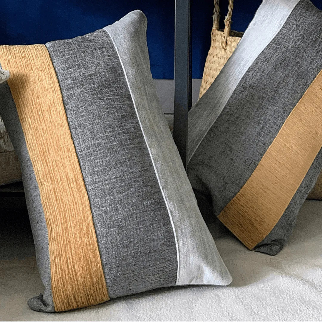 gray and gold lumbar pillow