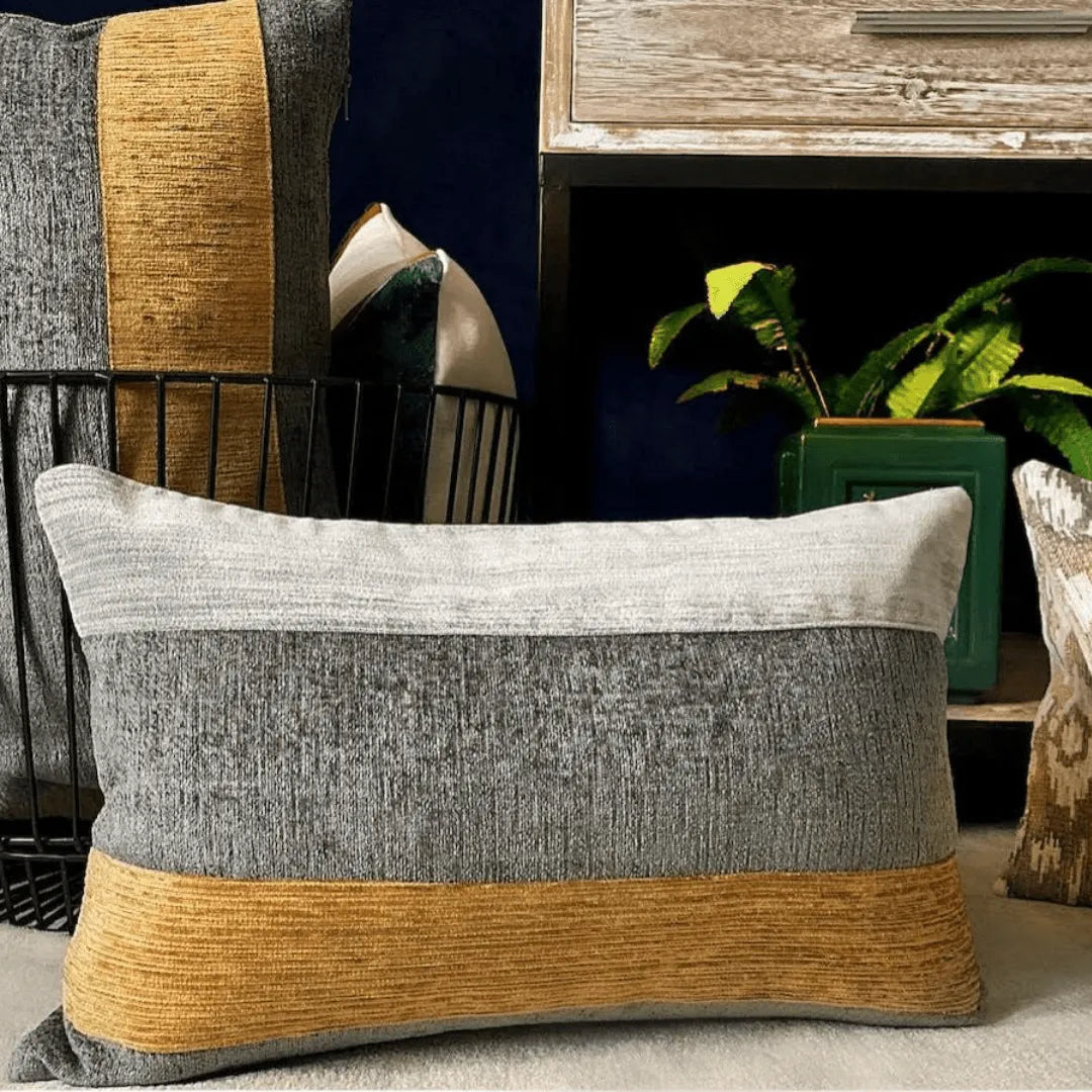 gray and gold lumbar pillow